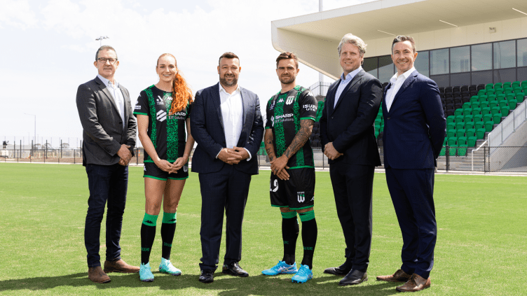 Western United players Hannah Keane and Josh Risdon pose with Jason Sourasis and members of YourLand and Johnson Controls to announce an investment partnership in the Wyndham City Stadium sports precinct with Western Melbourne Group